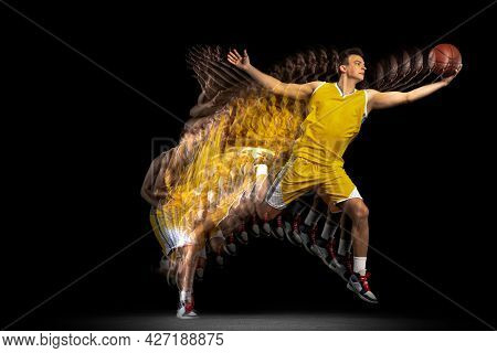Flight. Young Caucasian Basketball Player In Motion And Action Isolated On Dark Background With Stro