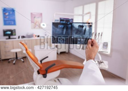 Orthodontist Doctor Holding Medical Teeth Jaw Radiography Examining Dental Oral Healthcare Working I