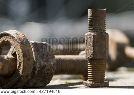 Old Rusty Bolt, Iron Rod With Screw Threads. Rusted Mechanical Components. Threaded Bolt And Nut. Di