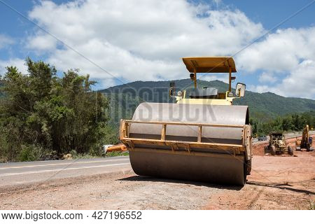 Roller Rolling Fresh Hot Asphalt On The New Road. Road Construction. The Road Rollers Working On The