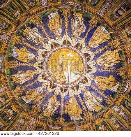 Ravenna, Italy - October 14, 2016: Mosaic cupola in the Neoniano Baptistery in Ravenna - John the Baptist baptizing Jesus and the Apostles round, cerca 5th century