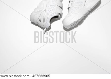Flat Lay Two White Unisex Sneakers On The Side At The Top With Free Space For Text Isolated On A Whi
