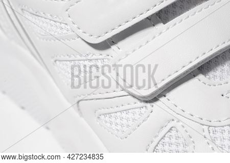A Close-up Photo Of The Velcro Fastener Of Sneakers. Macro Photo Of Childrens Sports White Sneakers 