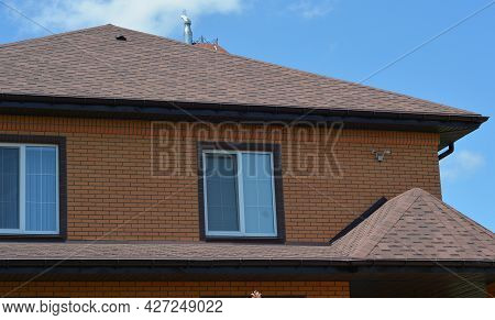 A Close-up Of A House With An Asphalt Shingled Roofing Construction, A Roof Ventilation Cap, Plastic