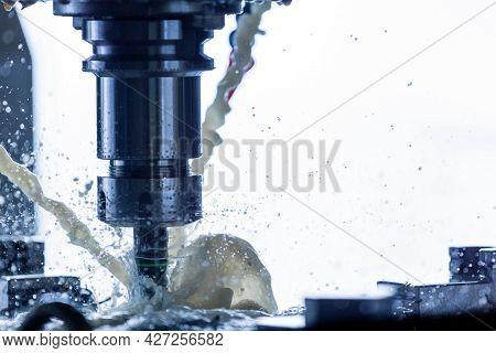 Close-up View Of Vertical Cnc Steel Milling Process With External Water Coolant Streams, Splashes An