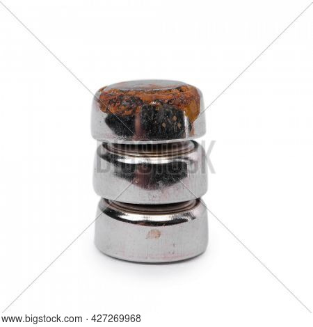 Group of small watch rusty batteries isolated on white background