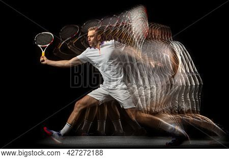 Portrait Of Young Man, Male Tennis Player In Motion And Action Isolated On Dark Background. Strobosc
