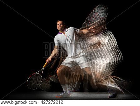 Portrait Of Young Man, Male Tennis Player In Motion And Action Isolated On Dark Background. Strobosc