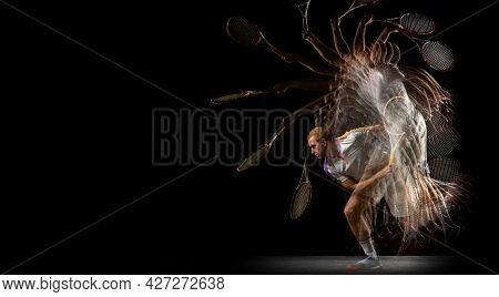 Portrait Of Young Man, Male Tennis Player In Motion And Action Isolated On Dark Background. Strobosc