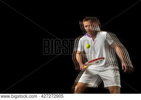 Portrait Of Young Man, Male Tennis Player In Motion And Action Isolated On Dark Background. Strobosc