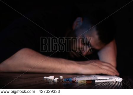 Overdosed Man At Table, Focus On Different Drugs
