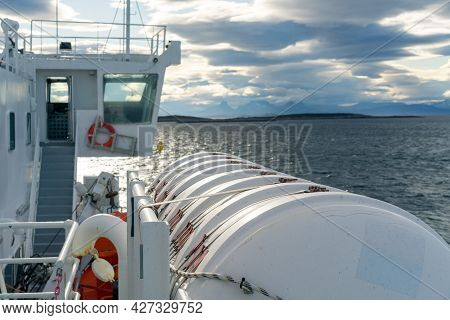 Big White Tank Attached To A Boat Sailing In The Sea By Lofoten Islands. Dramatic Clouds And Mountai