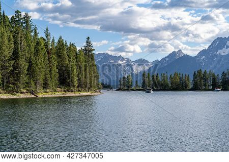 View Of Colter Bay In Grand Teton National Park, On Jackson Lake, As Boats Enter Towards The Marina