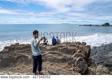 Washington, Usa - July 8, 2021: Tourist Man Takes A Selfie With A Smartphone On A Rock At Kalaloch B