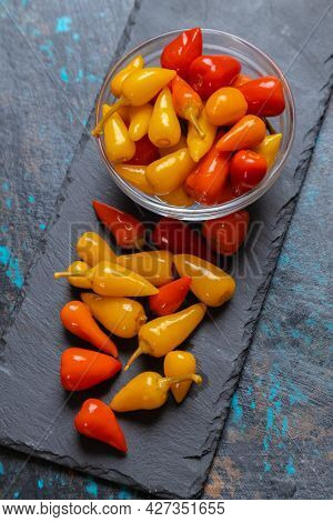 Pickled red and yellow hot chili peppers