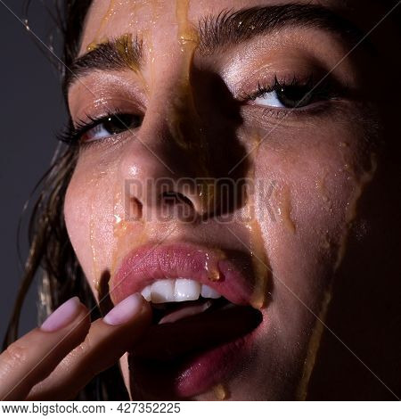 Sensual Woman With A Honey Facialmask Closeup. Beautiful Woman With Honey On Her Face. Healthy Perfe