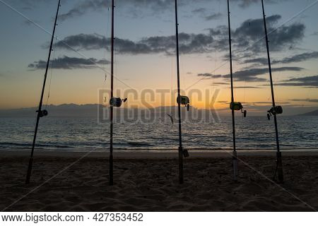 Fishing Rods Over A Beautiful Seascape. Sanset On Sea.