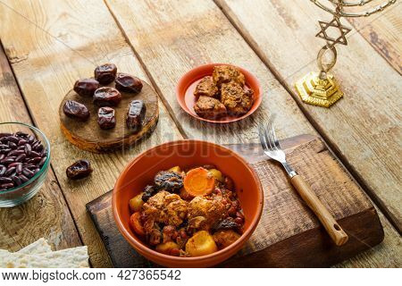 Jewish Dish Shuttle With Meat In A Dish On A Wooden Table Next To Matzo. Fork And Ingredients. Horiz