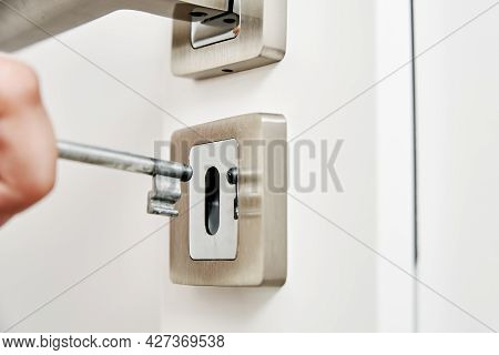 Woman Open Door Lock With A Key. Close Up Of Door Key In Keyhole
