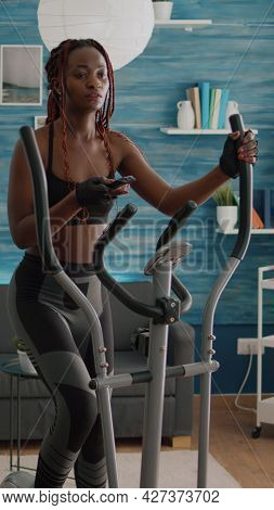 Cyclist Woman With Black Skin In Sportswear Training Body Muscle Using Elliptical Bicycle During Bod