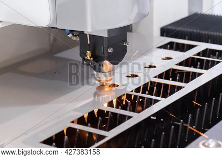 Automatic Cnc Laser Cutting Machine Working With Sheet Metal With Sparks At Factory, Plant. Metalwor