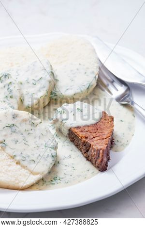 beef meat with dill sauce and dumplings