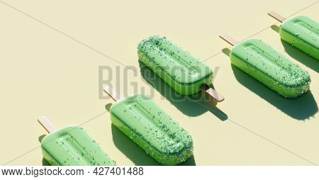 Apple green popsicles background. Fruity ice pop, ice cream treat