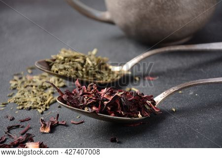 Various Kinds Of Dry Tea Bancha Green, Hibiscus, Butterfly Pea Flower Tea In Spoons On The Table