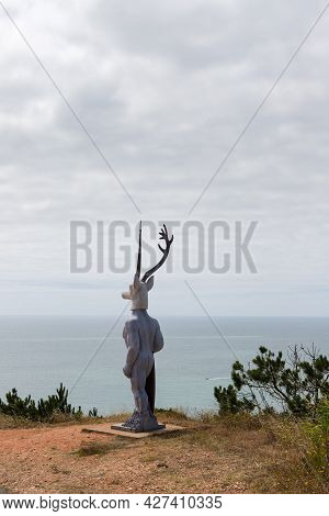 Nazare, Portugal - June 27, 2021: The Famous Statue Of The Deer Surfer The Surfista Da Nazare.