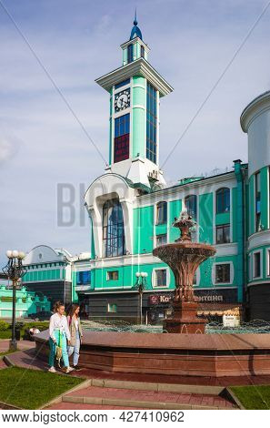 Novosibirsk, Russia - 20 July, 2021: Clock tower and fountain square of suburban train station