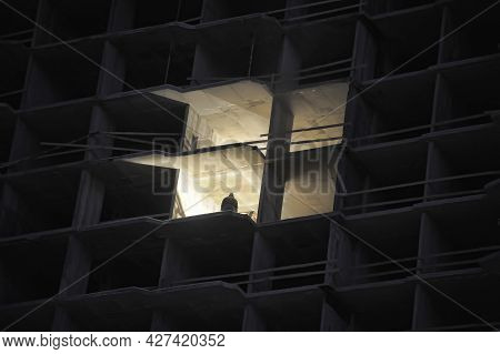 House Under Construction In The Evening With A Luminous Opening