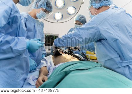 Medical Team In Surgical Gown Help Patient To Making Cpr Cardio Pulmonary Resuscitation In The Opera