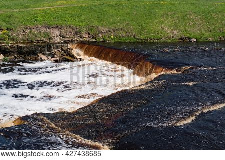 Waterfall On The Tosno River With Rapids And Stony Shore.  Sablino. Leningrad Region. Russia.