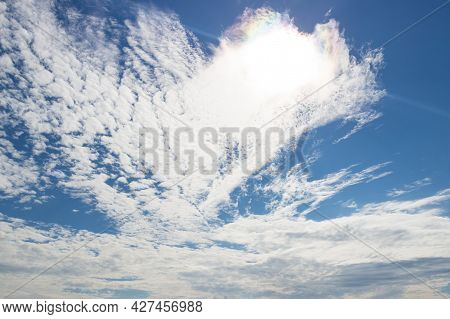 Blue Sky With White And Colorful Iridescent Clouds. Heaven Concept Background