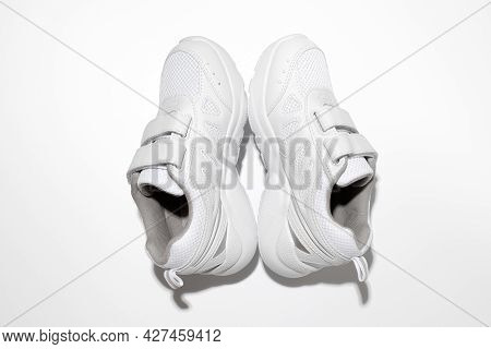 Minimalistic Flat Lay White Sneakers For Women Standing In The Form Of A Pyramid Or Tent Isolated On