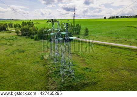 Transmission Tower Supporting An Overhead High Voltage Power Line. Energy Transmisson With Overhead 