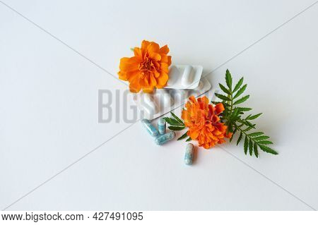 Dietary Supplement Capsules Of Marigold Flowers On White Background. Concept: Vision Improvement, Ey