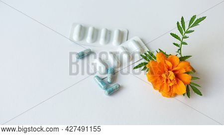 Dietary Supplement Capsules Of Marigold Flowers On White Background. Concept: Vision Improvement, Ey