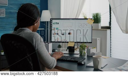 Closeup Of Black Student Browsing Financial Infographics Analyzing Statistics On Laptop Computer Wor
