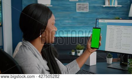 Student With Dark Skin Holding Phone With Mock Up Green Screen Chroma Key Looking At Isolated Displa
