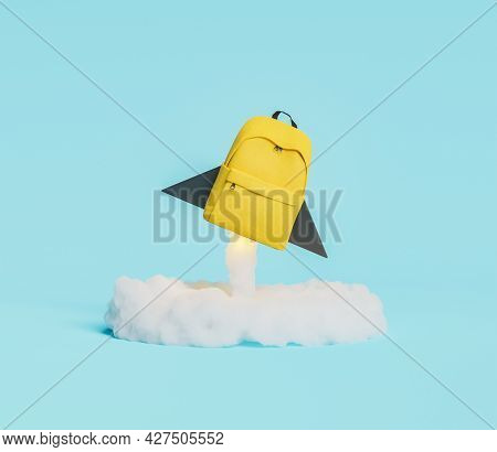Yellow Backpack In The Shape Of Rocket Taking Off With Illuminated Ignition Cloud. Concept Of Educat