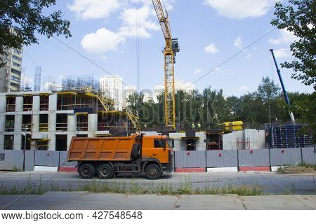 Mobile Crane At Construction Site. The Truck Is Parked Next To A Construction Site. Construction Of 