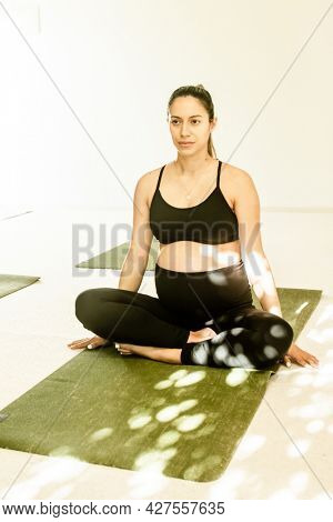 young pregnant woman practicing maternity yoga