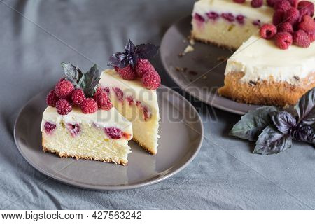 Raspberry Cheesecake Slices With Fresh Raspberries And Bazil Leaves On A Grey Plate, Whole Cheesecak