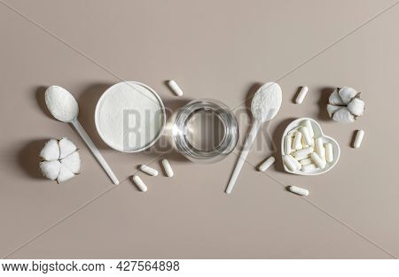 Collagen Powder And Pills On A Beige Background. Plant Or Fish Based Collagen Supplement. Healthy Li