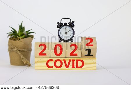 Covid-19 Pandemic In 2022 Symbol. Turned A Wooden Cube And Changed Words 'covid 2021' To 'covid 2022