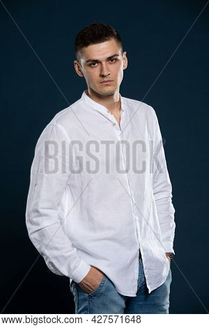 Portrait Of A Young Man Wearing A White Long Sleeve Shirt. A Determined Look.