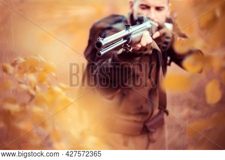 Autumn Hunting Season. Hunter Aiming Rifle In Forest. Barrel Of A Gun.