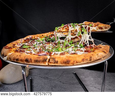Appetizing Pressed Pork Rinds Pizza With Cheese, Onion And Cilantro, On A Base And A Dough Ball At T
