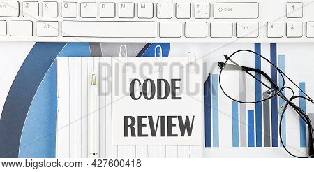Office Desk Table With Keyboard, Chart,glasses ,pen. Top View With Text Code Review